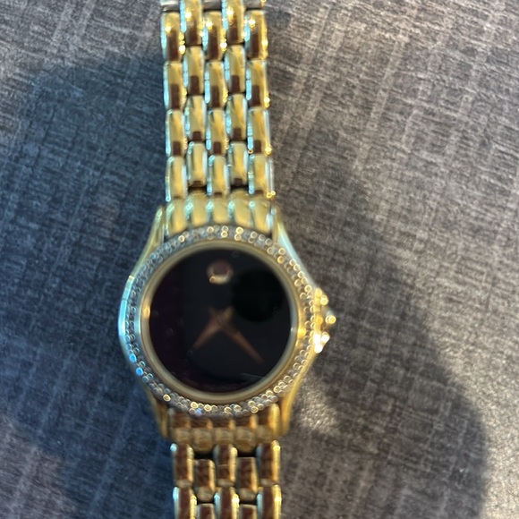 Movado Anniversary Gold with black face and diamonds